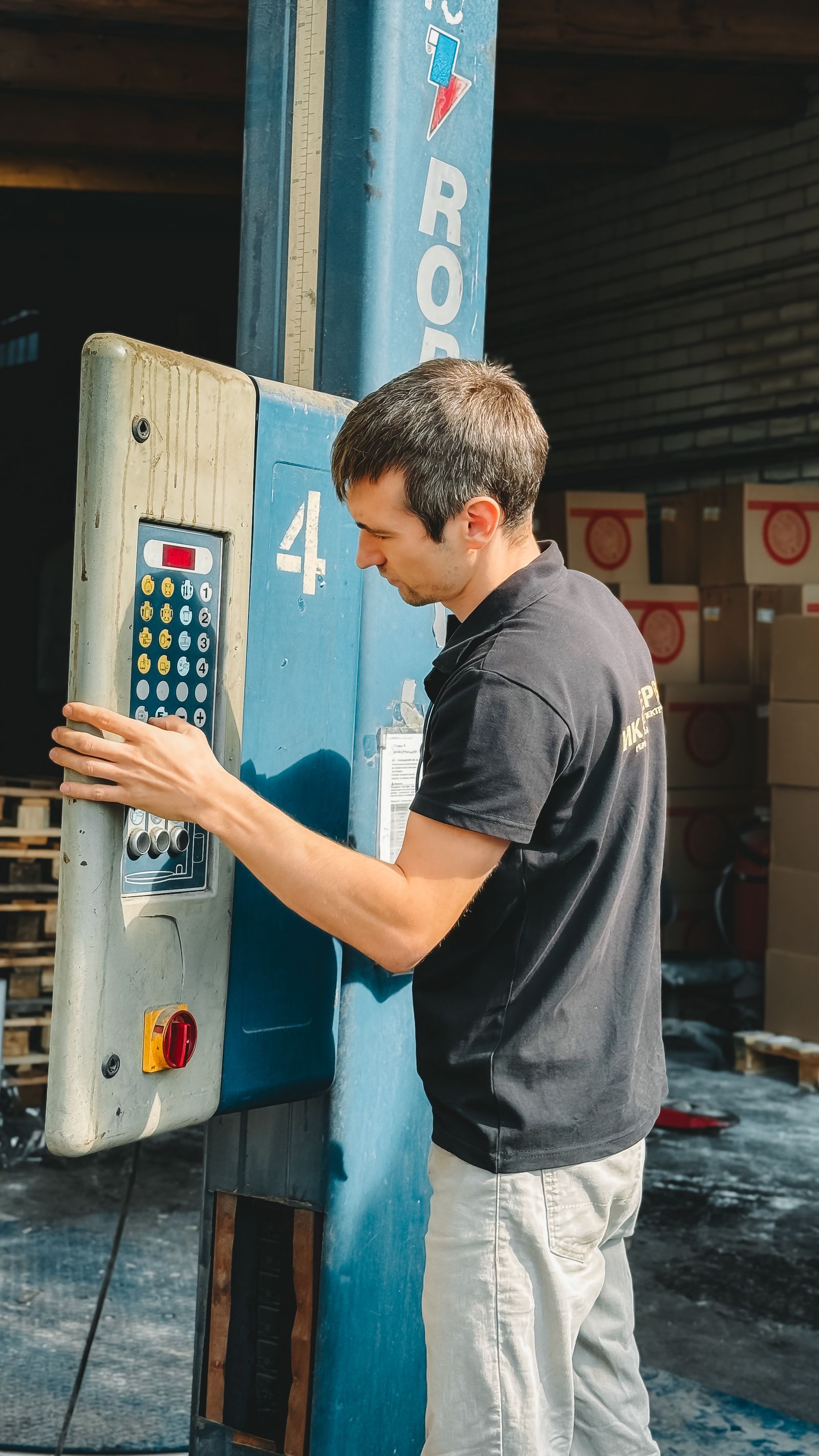 Warehouse employee operating cargo loading equipment
